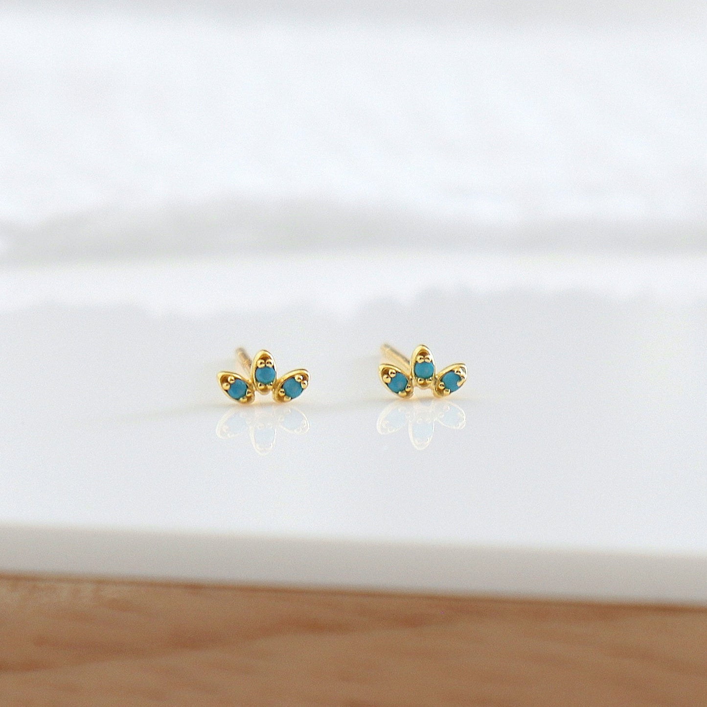 Petites boucles d'oreilles clous fleur trois pétales zircons turquoises
