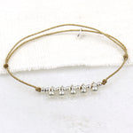 bracelet femme cordon lurex doré clair avec des perles qui pendent en argent 925